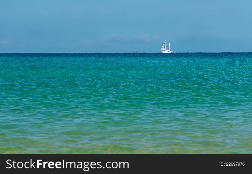 White sailboat on the azure sea