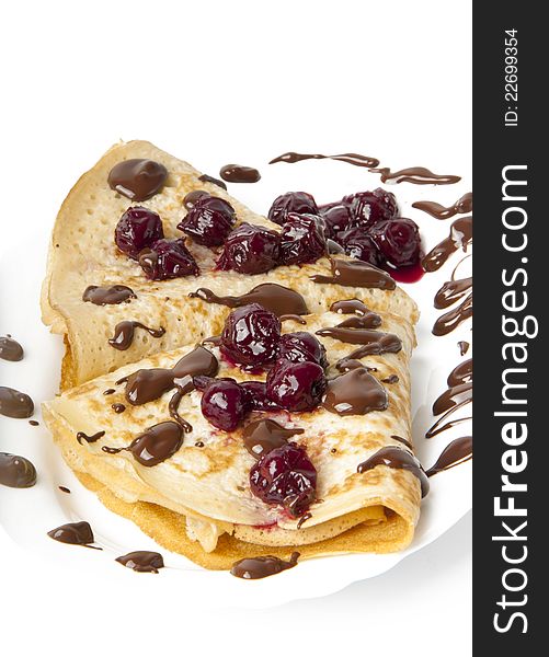 Delicious pancakes with cherry jam and chocolate icing