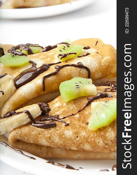 Delicious crepes stuffed with bananas and kiwi fruit. Delicious crepes stuffed with bananas and kiwi fruit