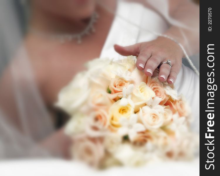 Details of bride focusing on engagement ring and bouquet with other accessories blurred in background special effects applied to enhance dreamy quality and blur. Details of bride focusing on engagement ring and bouquet with other accessories blurred in background special effects applied to enhance dreamy quality and blur
