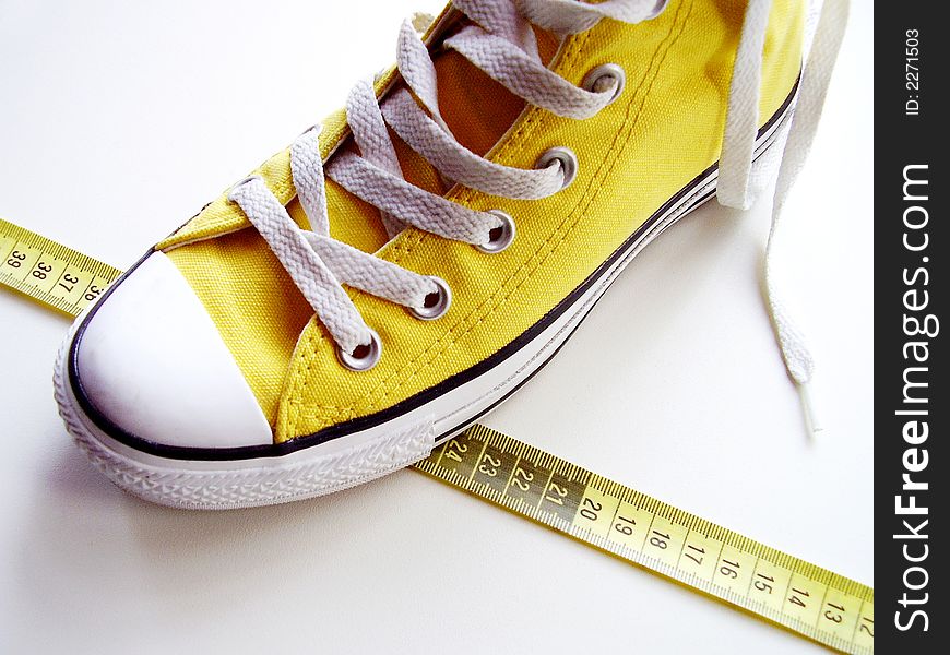 Yellow nice shoes on a tape measure