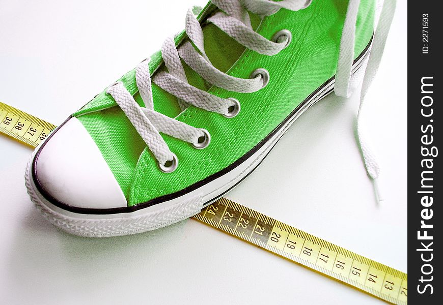 Green nice shoes on a tape measure