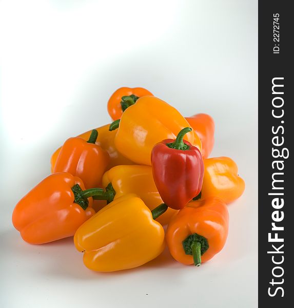 A grouping of multicolored bell peppers from above. A grouping of multicolored bell peppers from above