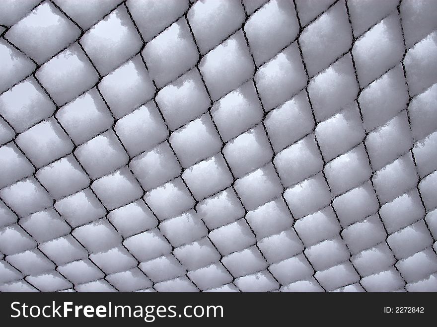 A snow covered net after a heavy wet spring snow. A snow covered net after a heavy wet spring snow