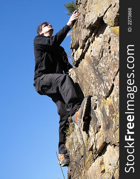 Sportsman climbing on a rock