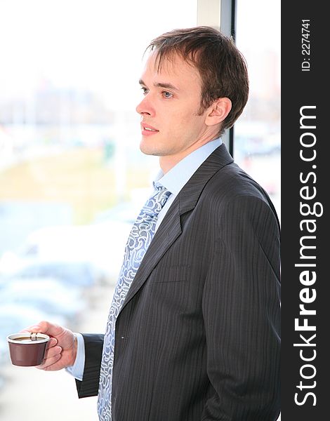 Businessman with coffee and window