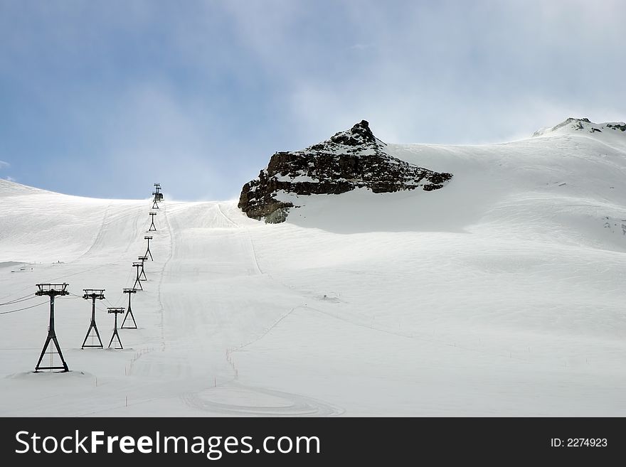 Ski slopes and a lift in the Swiss alps. Ski slopes and a lift in the Swiss alps