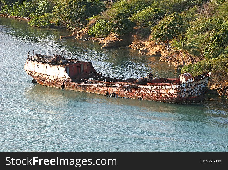 Old rusted skeleton of a ship in the water. Old rusted skeleton of a ship in the water