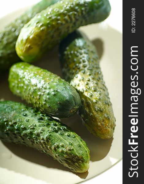 Cucumbers on white cook-table