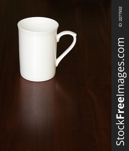 White Empty Coffee Cup On A Dark Wooden Table, Reflection. White Empty Coffee Cup On A Dark Wooden Table, Reflection