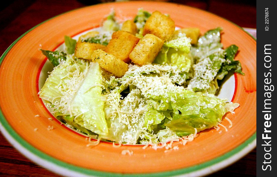 A bowl of salad served in a small restaurant. A bowl of salad served in a small restaurant