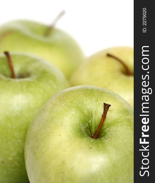 Many green apples on a white background