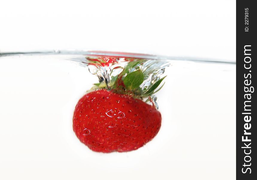 Water drops and strawberries in water. Water drops and strawberries in water