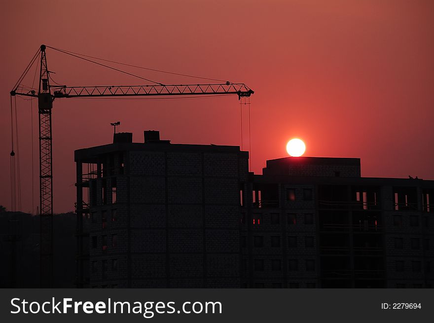 Construction Site Sillouhette with tower Crane at Sunset. Construction Site Sillouhette with tower Crane at Sunset