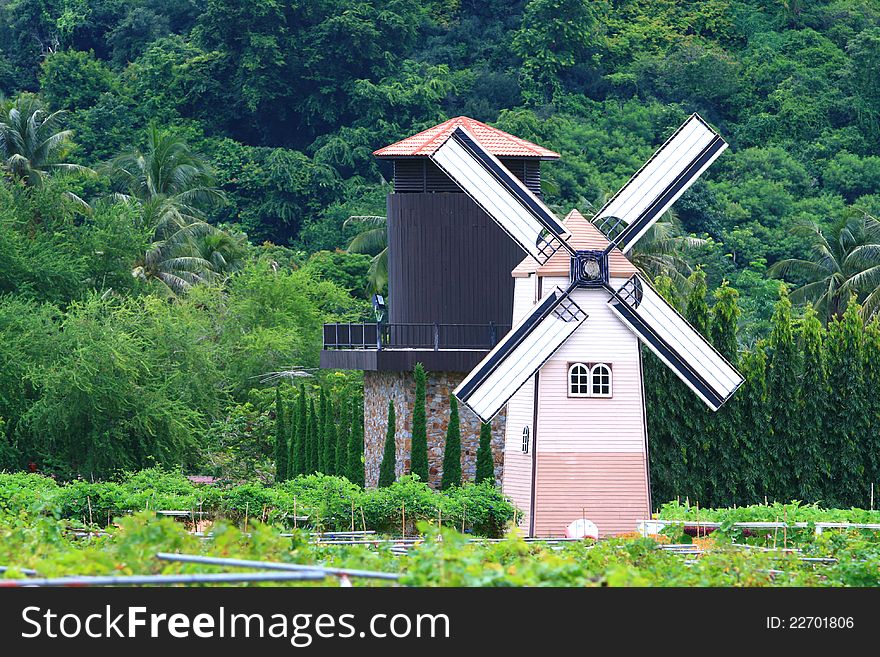 Traditional Old dutch windmill in Thailand with Agriculture Silo