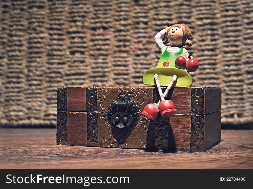 A doll on a wooden box