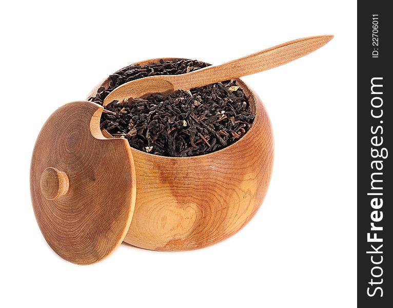 Black tea leaves on wooden ware