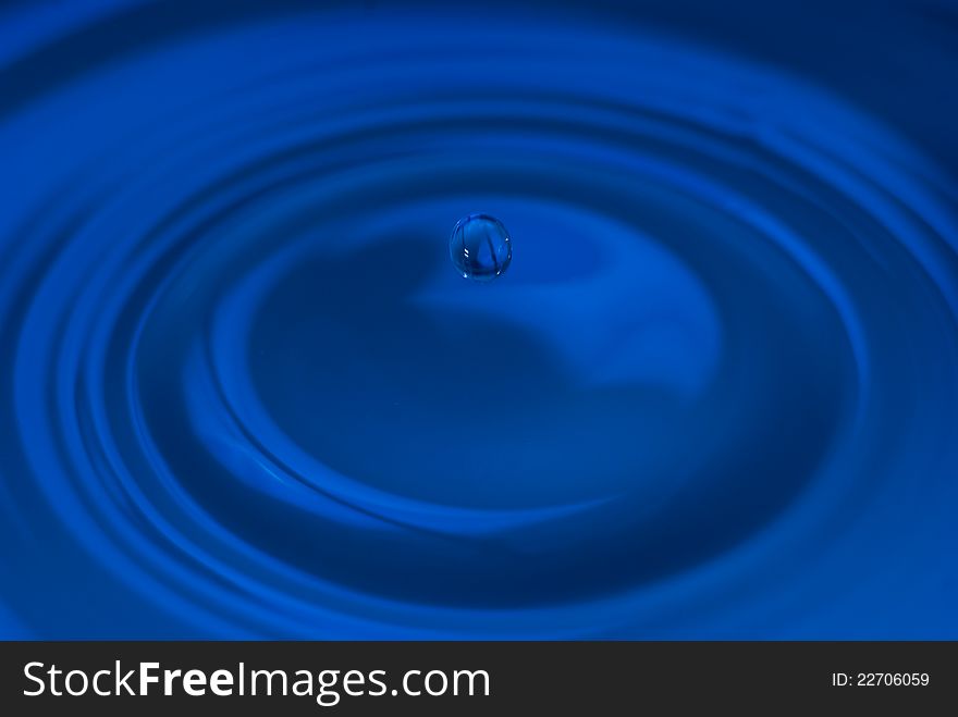 The round transparent blue drop of water, fall