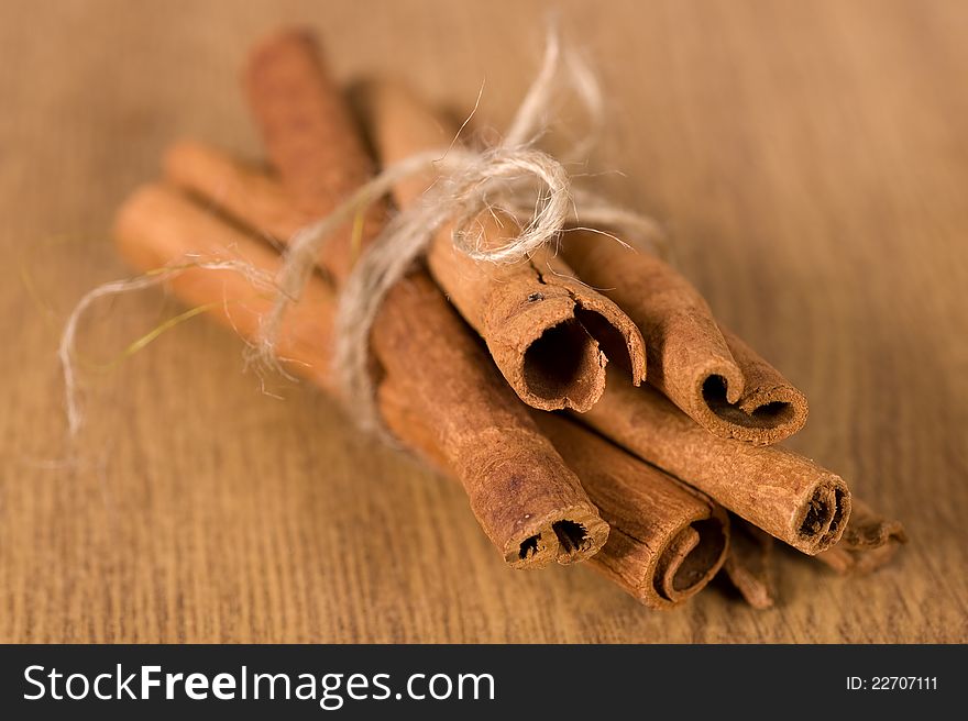 Fragrant cinnamon sticks on a wooden background