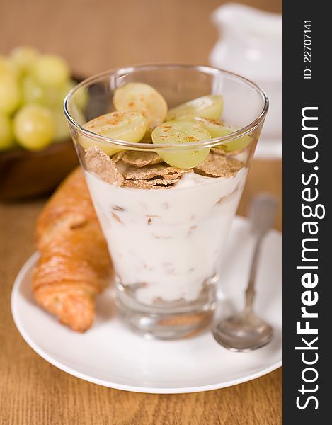 Muesli, yoghurt, croissants and grapes