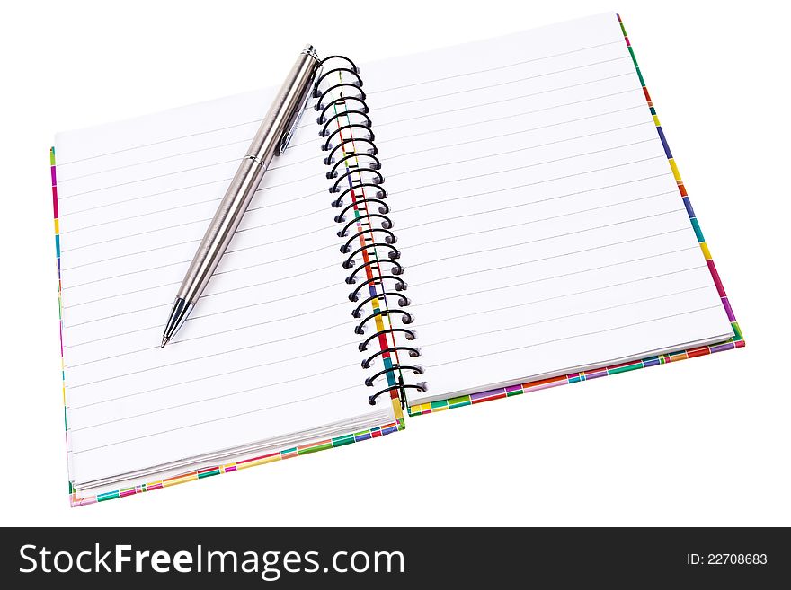 Open ring notepad with silver ballpen isolated over white background. Open ring notepad with silver ballpen isolated over white background.