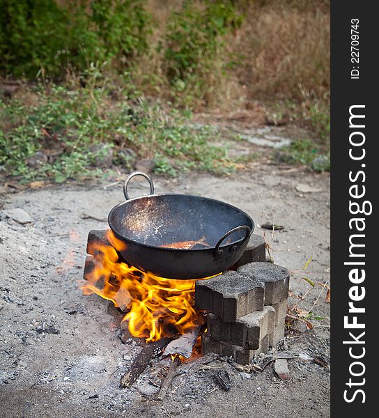 Cooking  three fresh water fish in oil on  open fire. Cooking  three fresh water fish in oil on  open fire