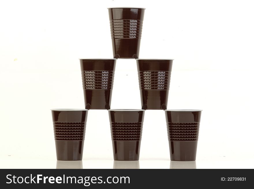 Stack of brown plastic cups arranged on white. Stack of brown plastic cups arranged on white.