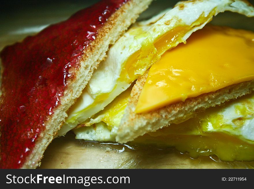 Fried egg sandwich with cheese and grape jelly. Fried egg sandwich with cheese and grape jelly