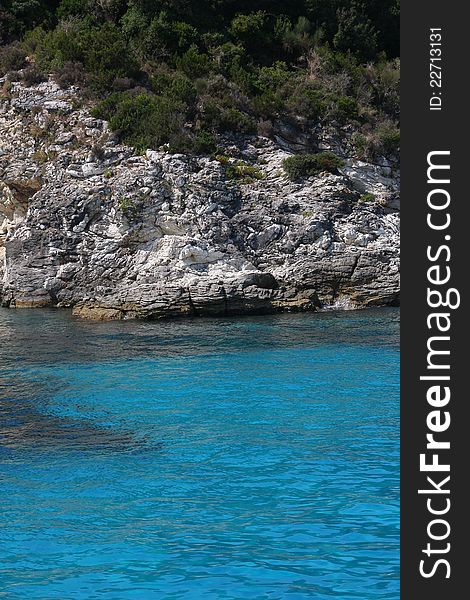 Rocky sea shore with amazing blue water. Rocky sea shore with amazing blue water