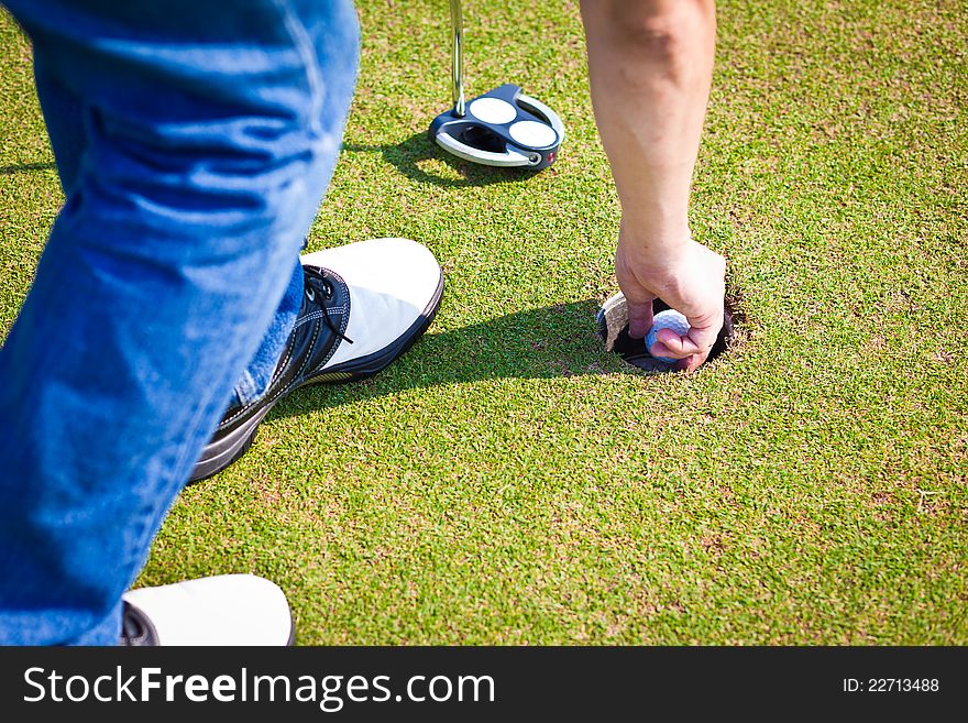 Closeup Person holding golf ball