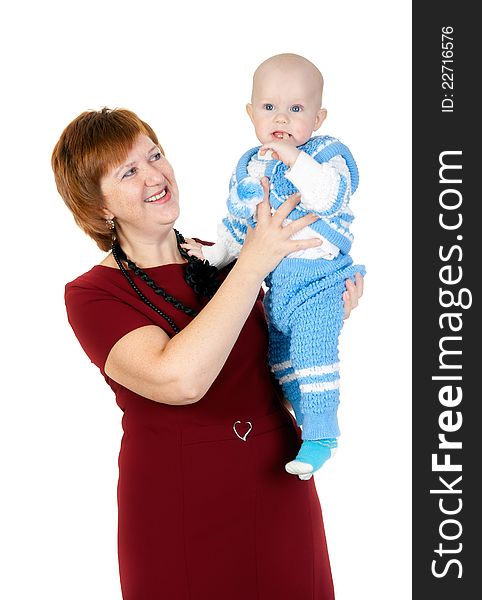 Grandmother with her grandson in her arms in the studio on a white background. Grandmother with her grandson in her arms in the studio on a white background