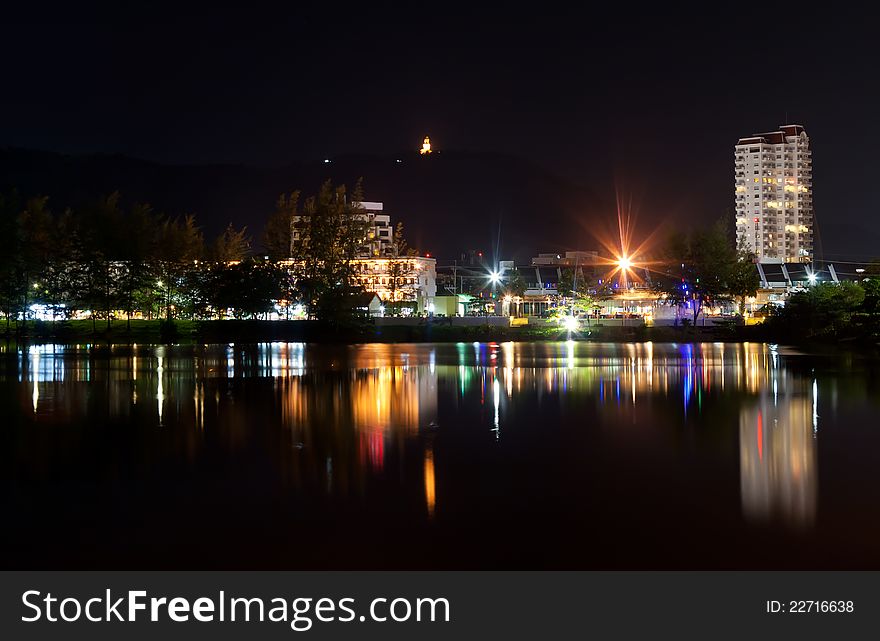 View the city at night, the reflection in the sea