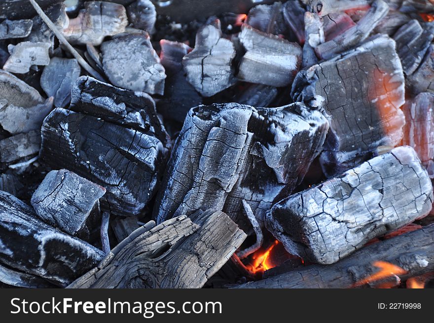 Red burning firewood of campfire