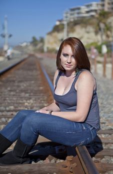Cute Teen Girl Sitting On Rail Road Tracks Royalty Free Stock Image