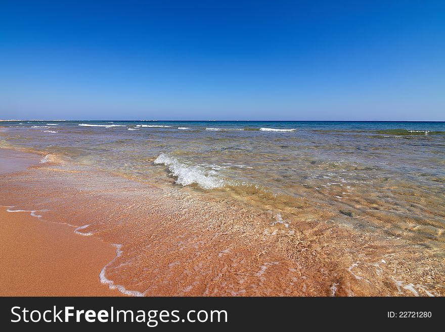 Seaview of coastline with tranquil water and blue sky as background. Seaview of coastline with tranquil water and blue sky as background