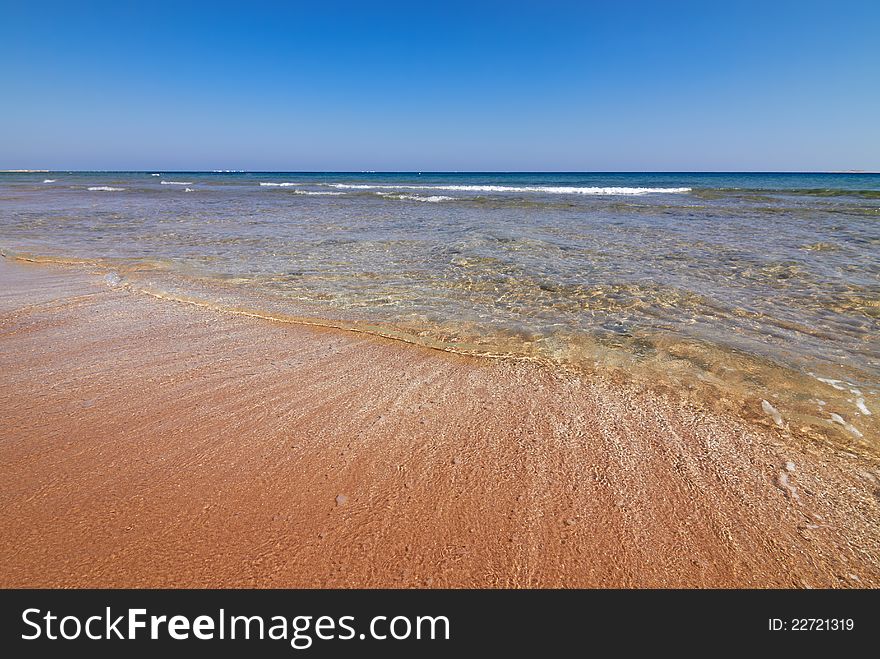 Seaview of coastline with tranquil water and blue sky as background. Seaview of coastline with tranquil water and blue sky as background