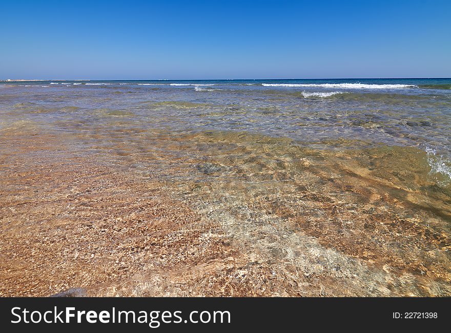 Tranquil sea water motion on a beach as background