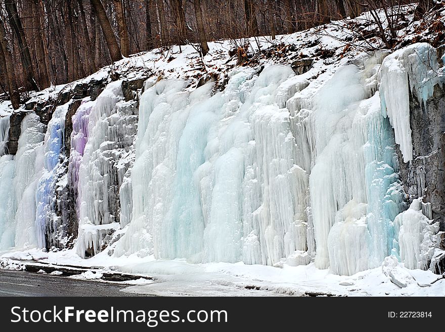 Icicles in pastel shades flowing over Mont Royal slope in Montreal, Quebec, Canada. Icicles in pastel shades flowing over Mont Royal slope in Montreal, Quebec, Canada