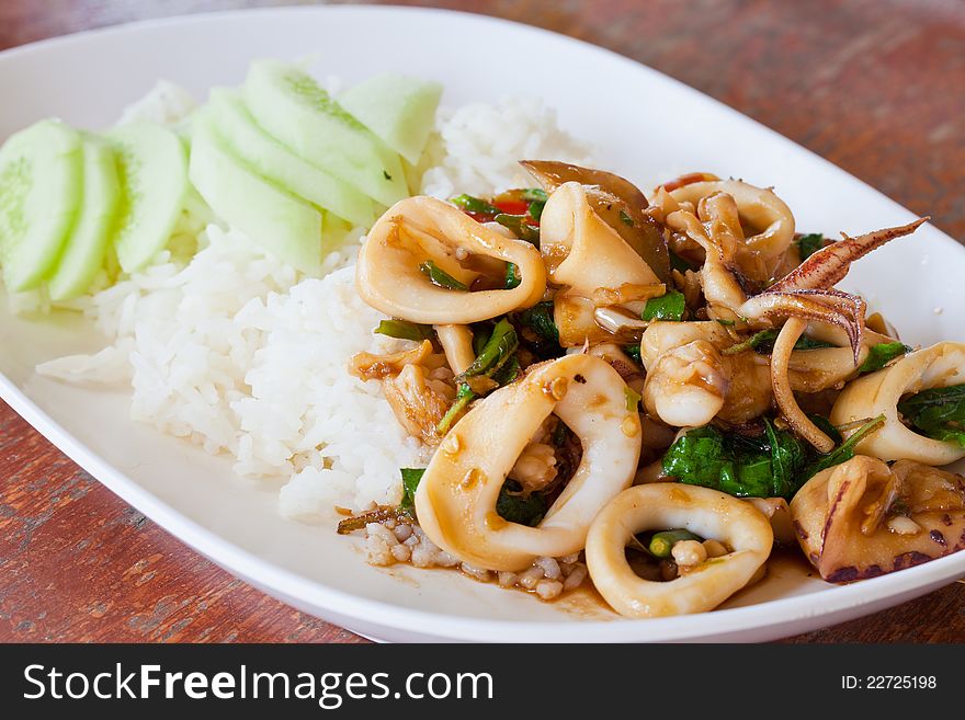 Plain rice cuttlefish with basil leaves