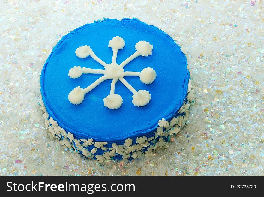 Snowflake-decorated cake. Displayed on artificial snow to add to the winter theme. Snowflake-decorated cake. Displayed on artificial snow to add to the winter theme.