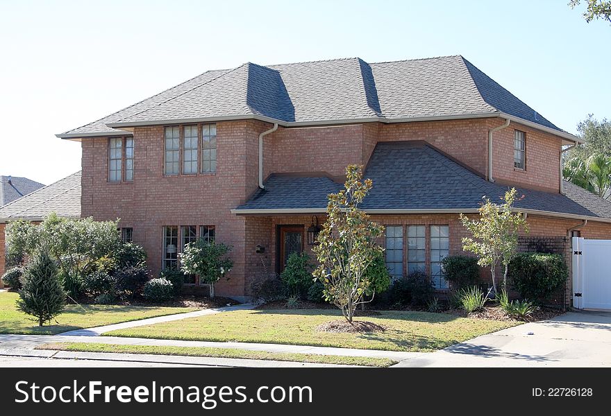 It is a red brick suburban house in USA.