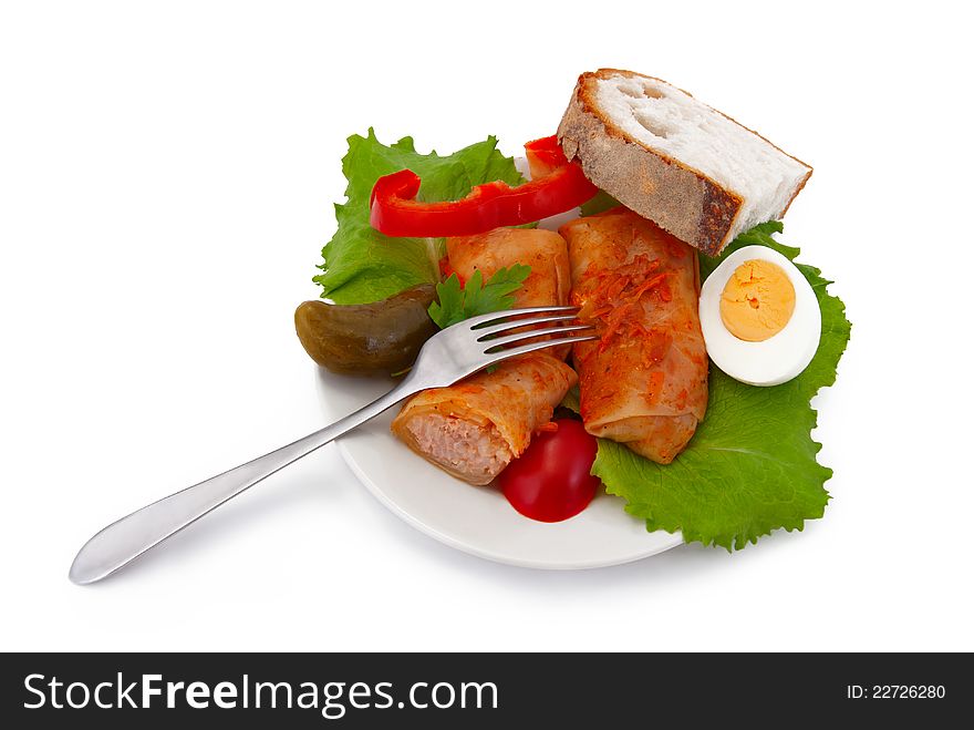 Stuffed cabbage on plate, fork and bread, isolated on white