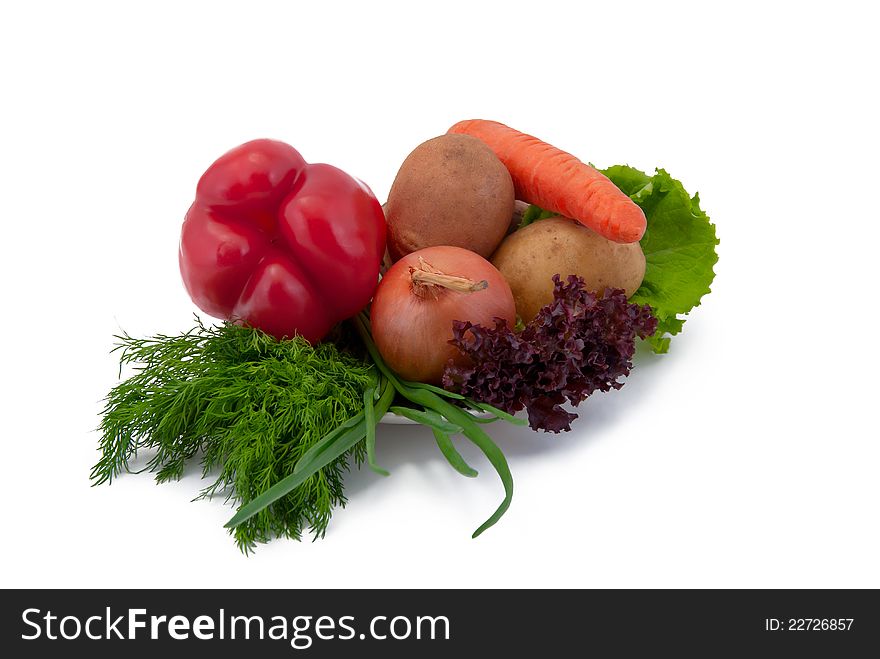 Vegetables on a plate, isolated on white background