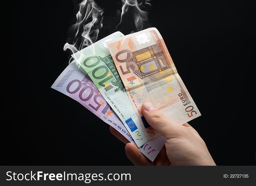 Hand taking euros to smoke