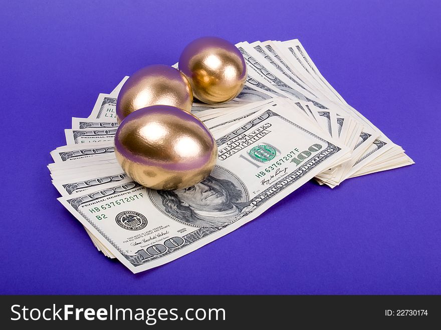 Golden eggs. A symbol of making money and successful investment on blue background