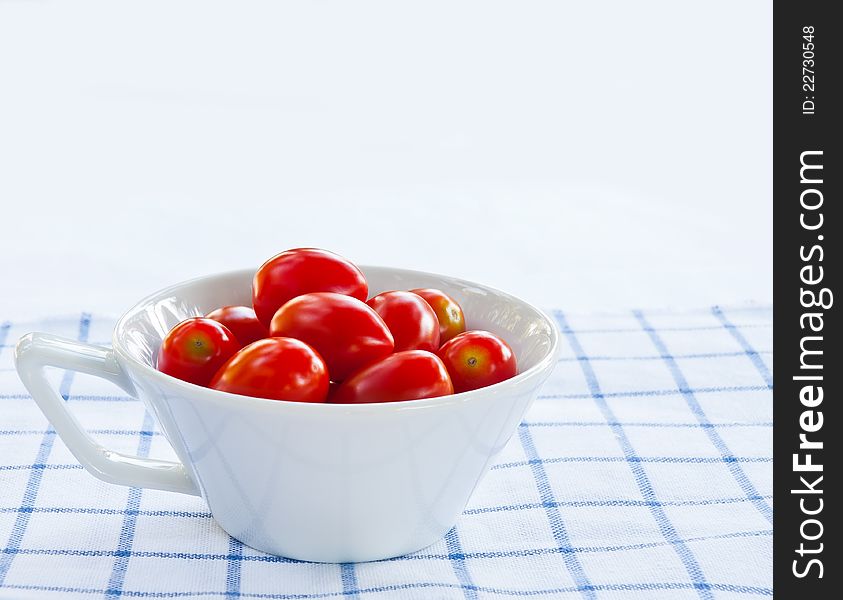 White cup of fresh red tomatoes. White cup of fresh red tomatoes