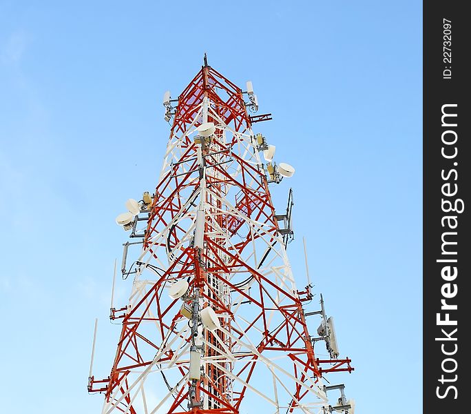 Red and white tower of communications with their telecommunications antennas