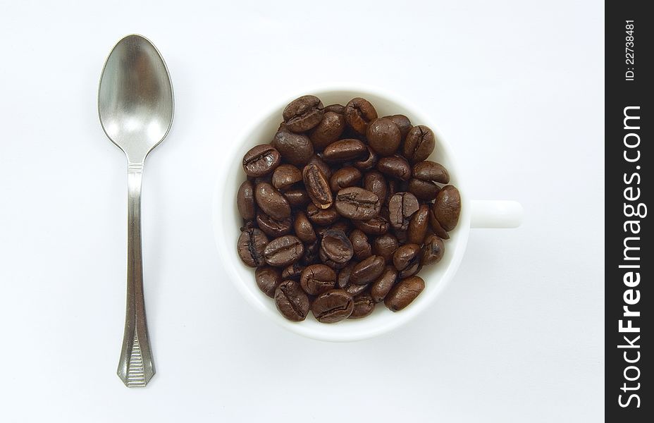 A cup with coffee beans. A cup with coffee beans