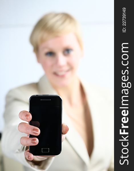 Image of a business lady offering her mobile phone to you. Image of a business lady offering her mobile phone to you