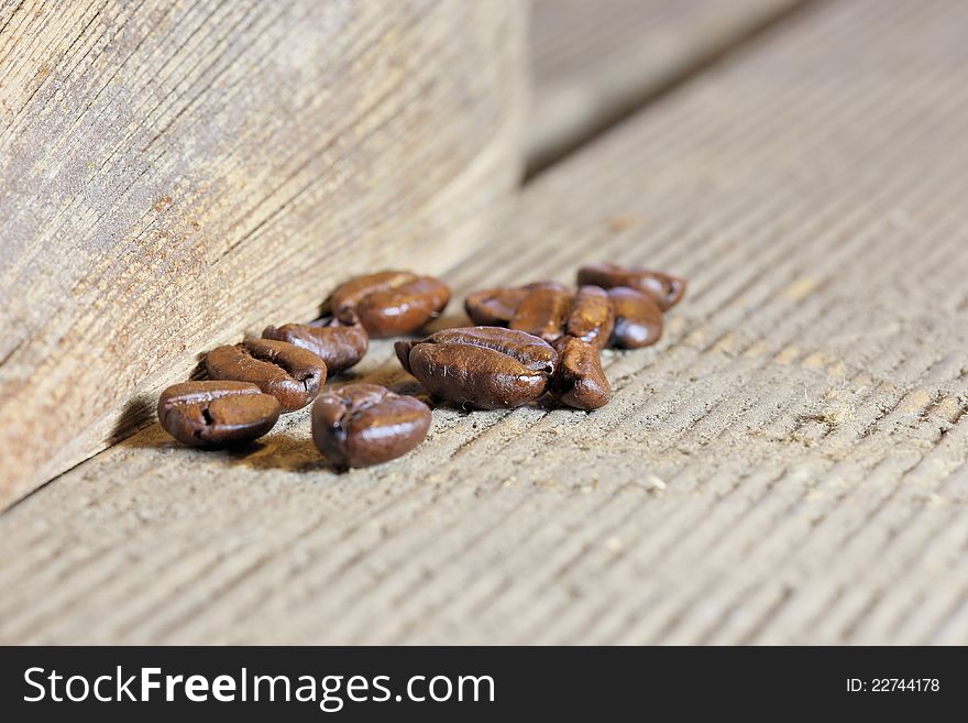 Coffee beans at wooden plate. Coffee beans at wooden plate